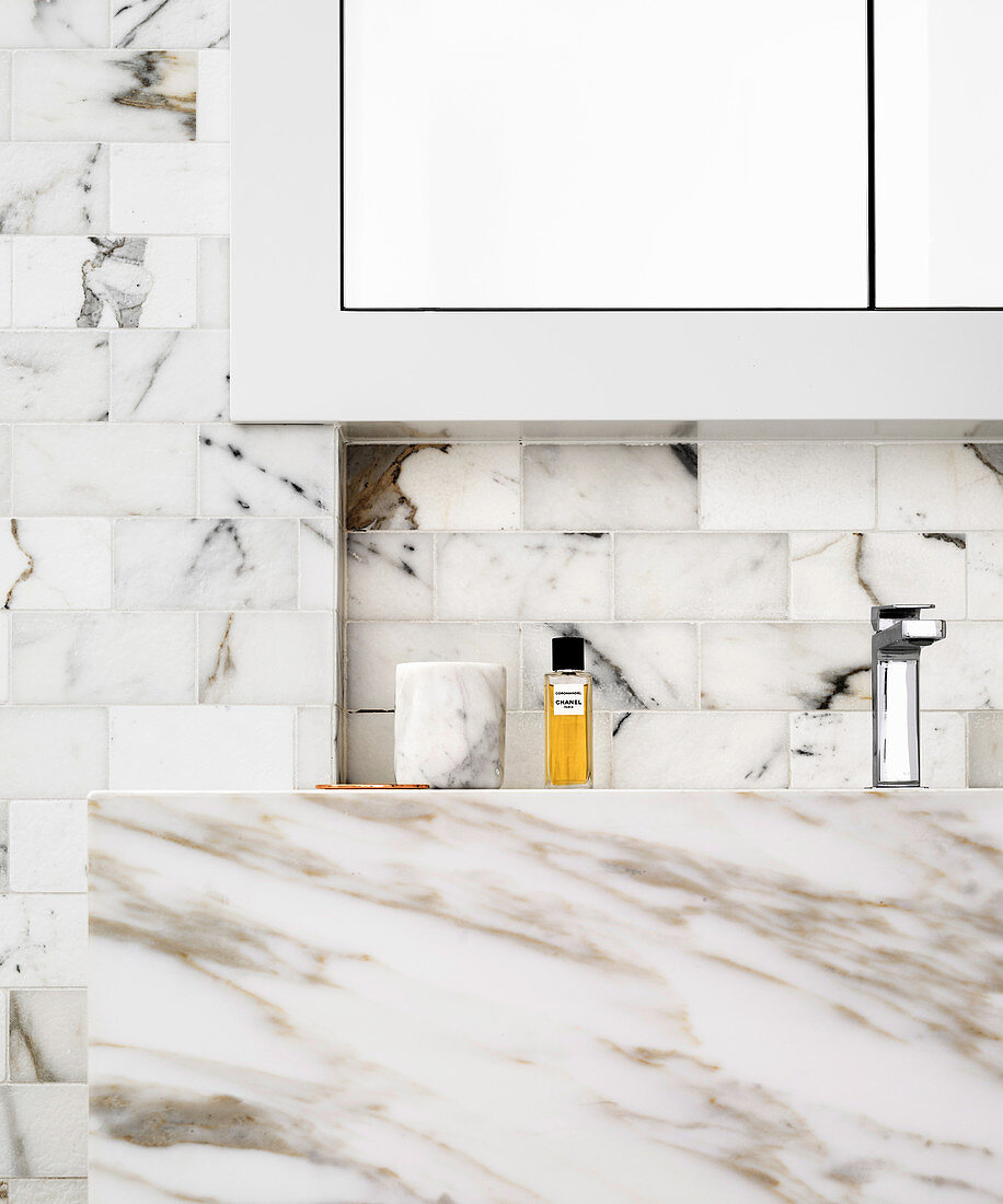 Marble vanity and marble wall tiles in the bathroom