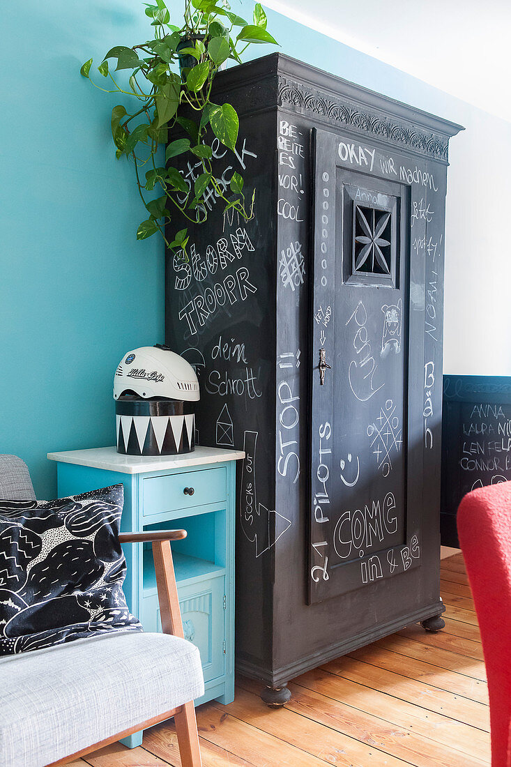 Old cupboard painted with chalkboard paint and covered in chalk lettering
