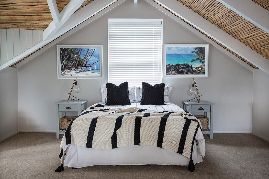Double bed in symmetrically arranged attic bedroom