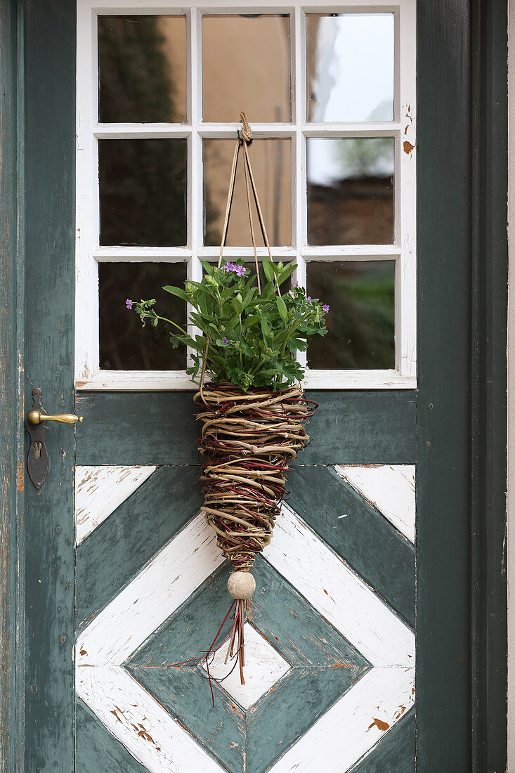 Wicker hanging basket on rustic front door