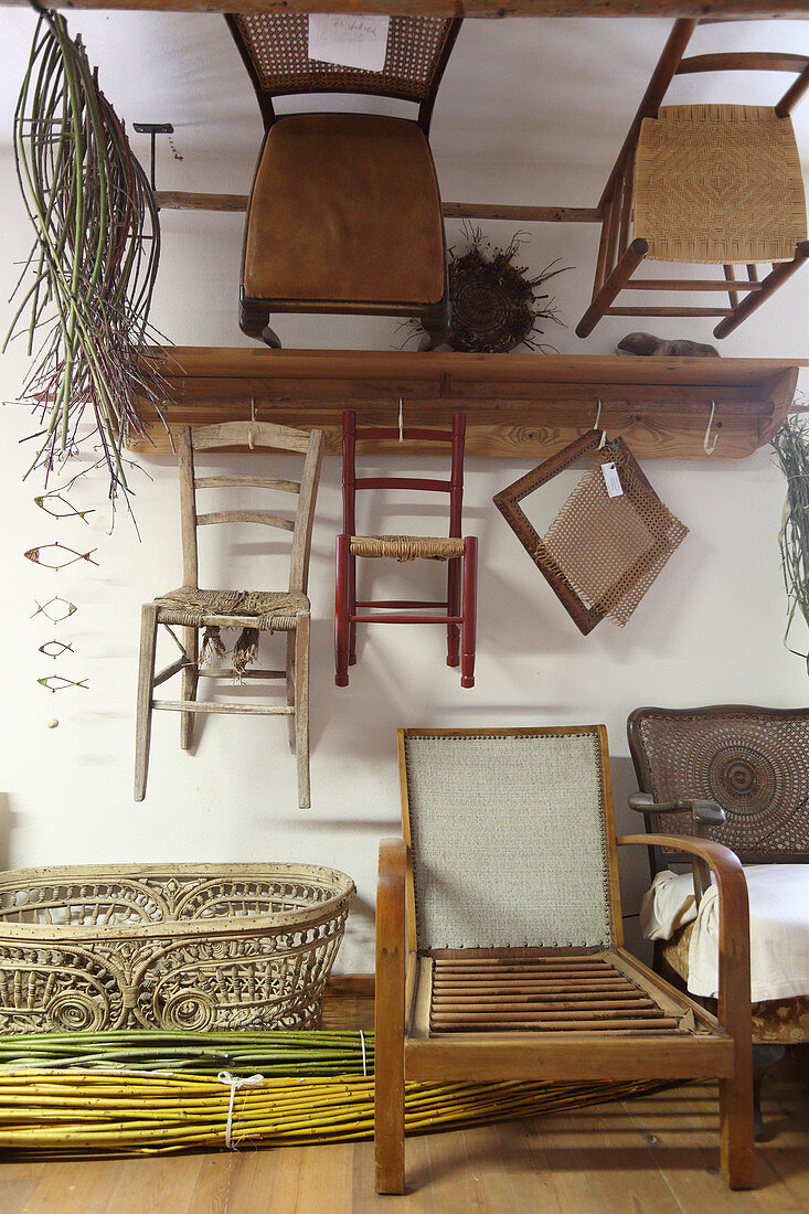Old chairs on wall in basketry workshop