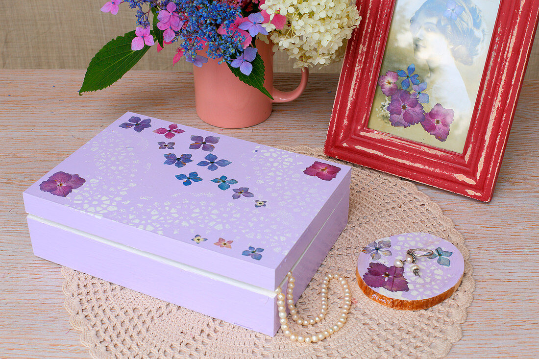 Purple jewellery box decorated with lace motif and pressed flowers