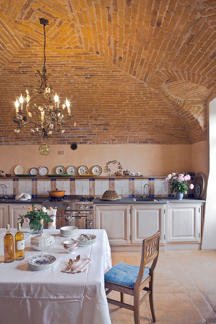 Gedeckter Tisch in mediterraner Küche mit Gewölbedecke