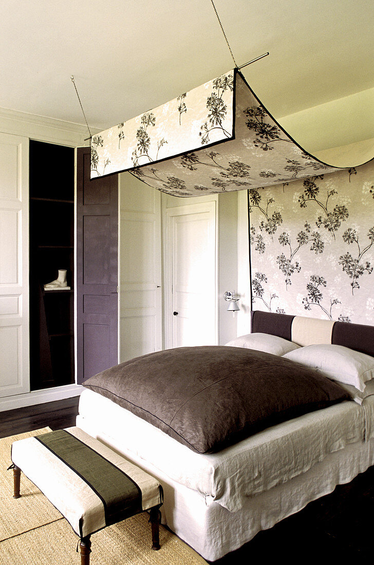 Floral canopy above bed in bedroom with fitted wardrobes