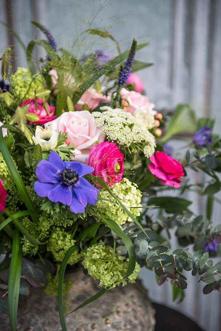 Colourful spring bouquet with blue, pink and green flowers