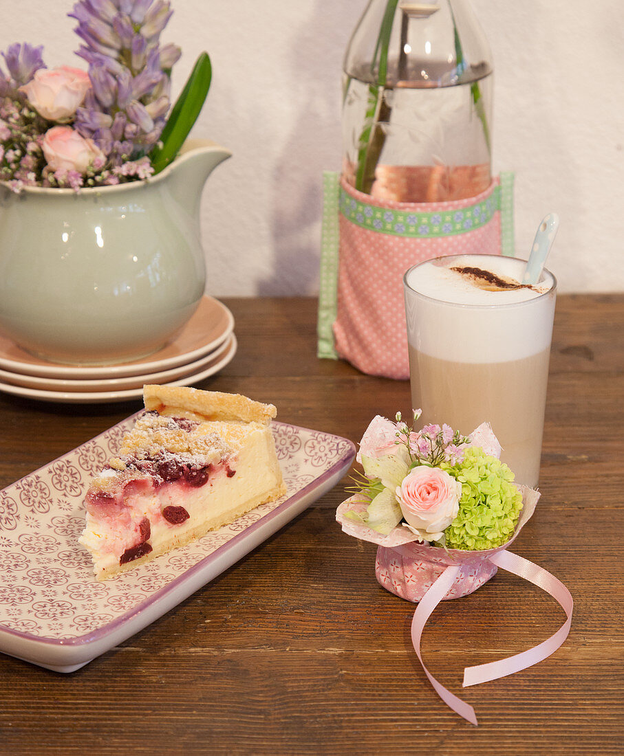 Coffee and cake with vintage-style crockery and flower arrangements