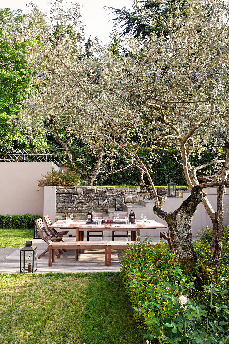 Set table, chairs and benches in Mediterranean garden