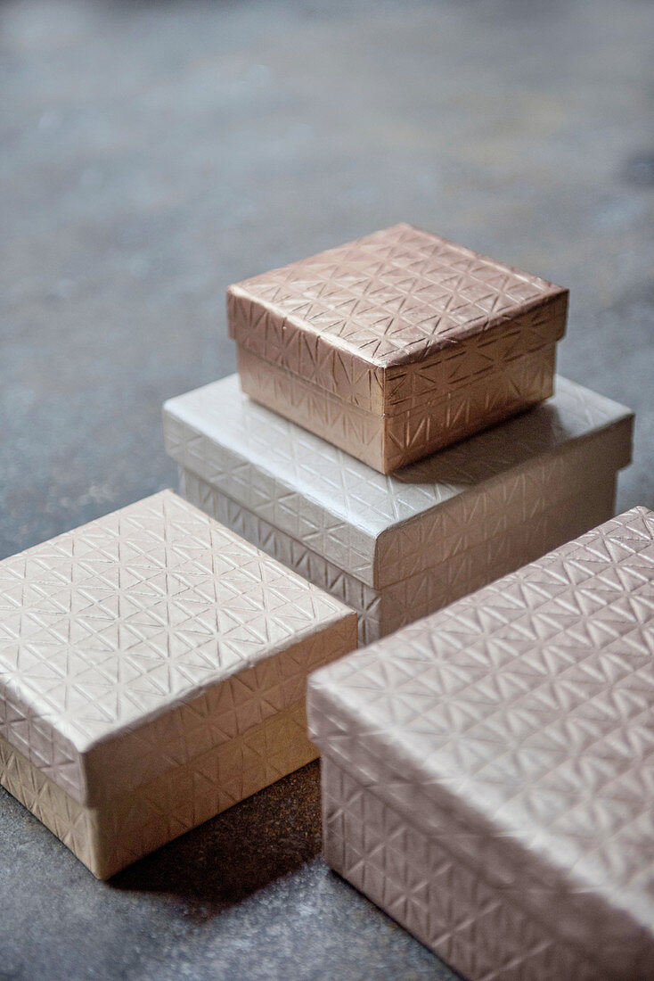 Four boxes in shades of champagne with structured surfaces