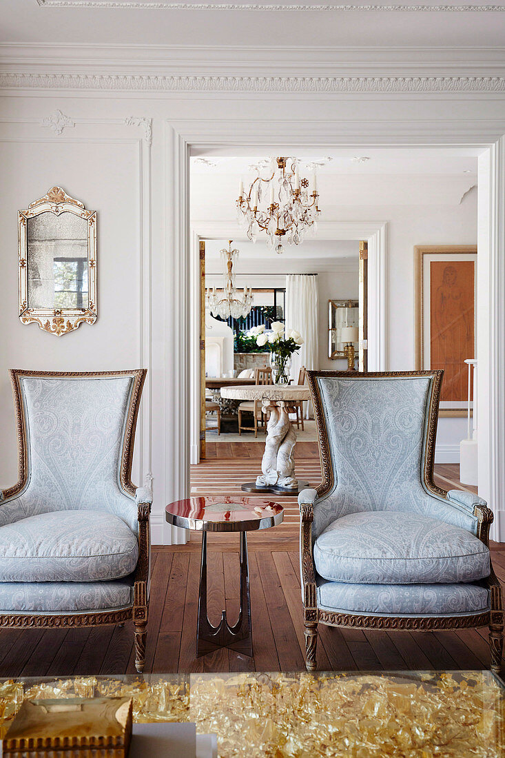 French armchairs with side table and coffee table in gold in elegant salon