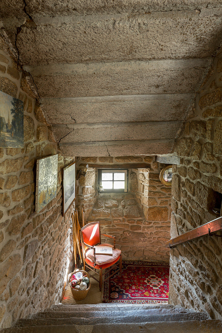 View down staircase in old house with stone walls