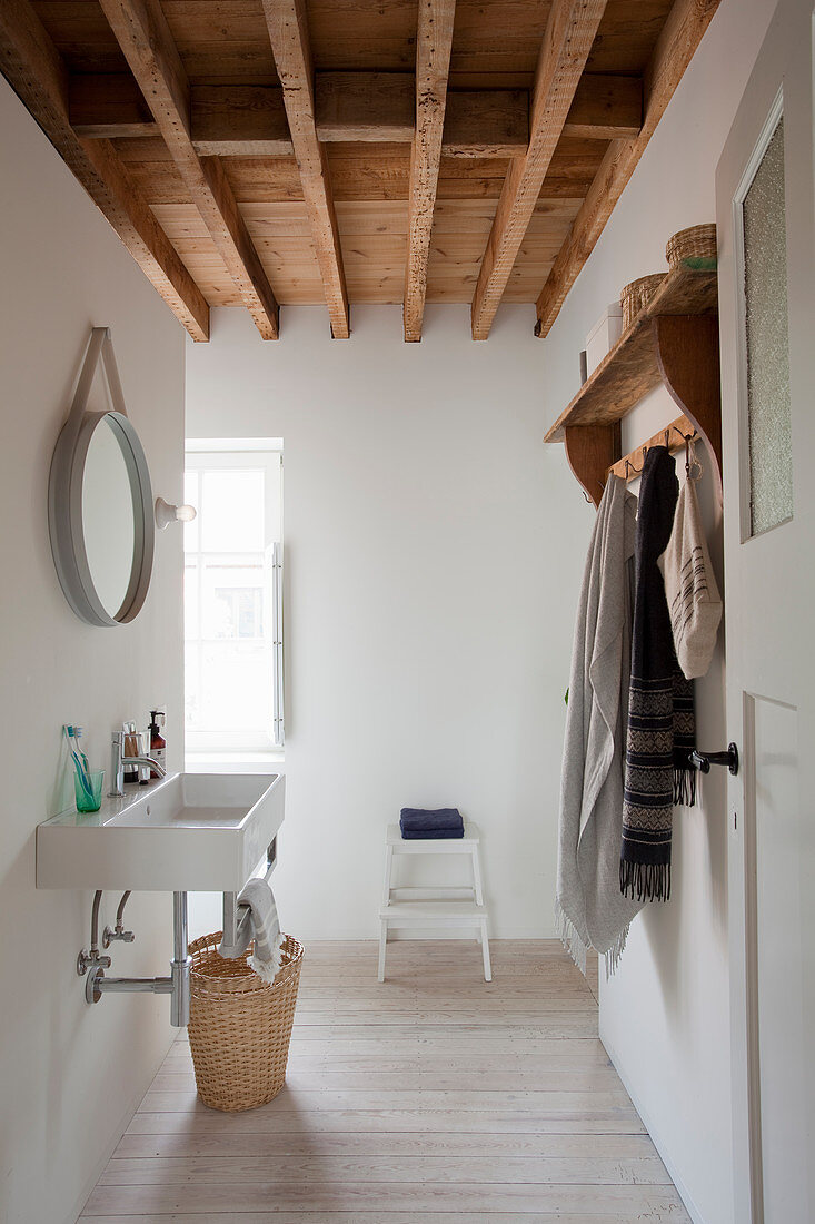 Simple white bathroom with wood-beamed ceiling