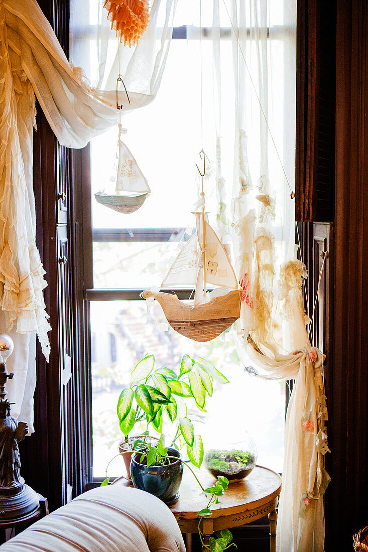 Artistically draped curtains and small sailing boats