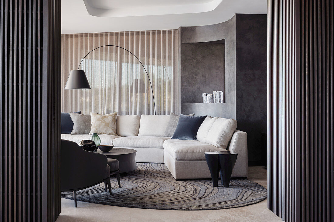 Elegant living room with upholstered furniture and dark wall