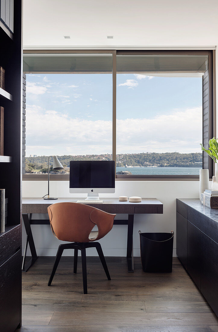 Arbeitszimmer mit Designer-Armlehnstuhl und Meerblick