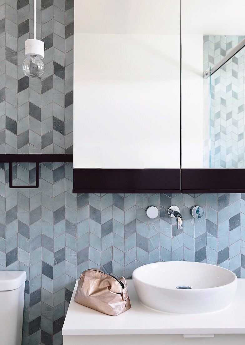 Wash basin with countertop basin, above it a wall tap and mirror cabinet, 3D tile pattern