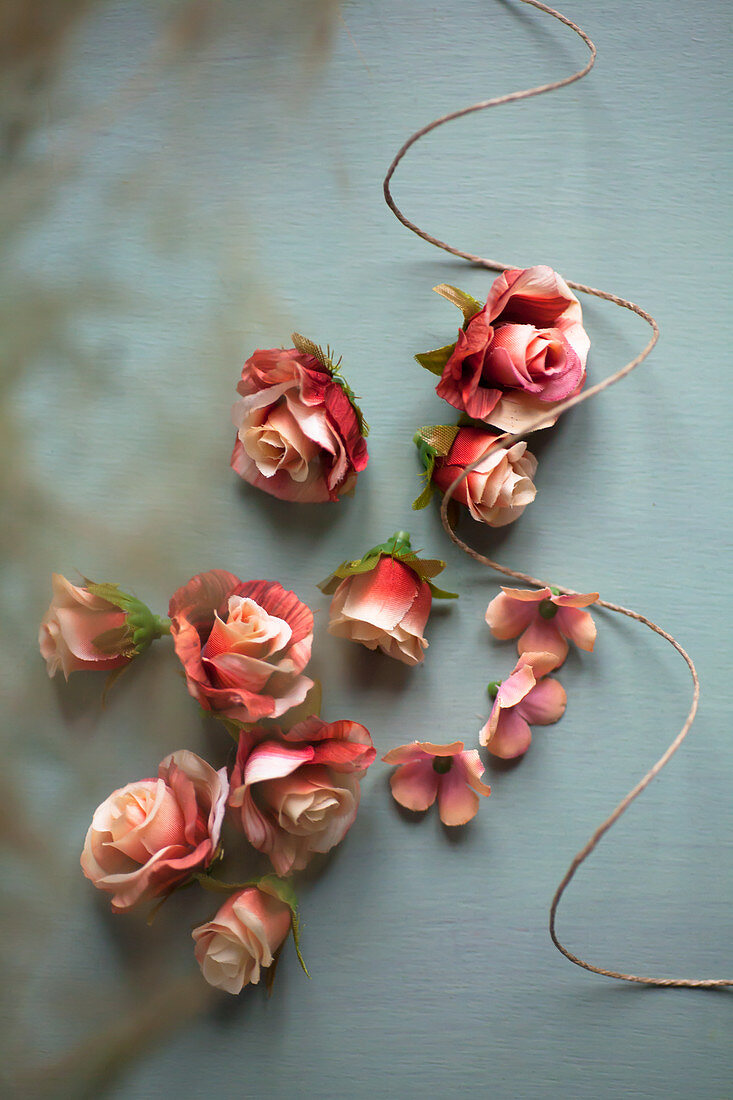 Roses and twine on grey surface