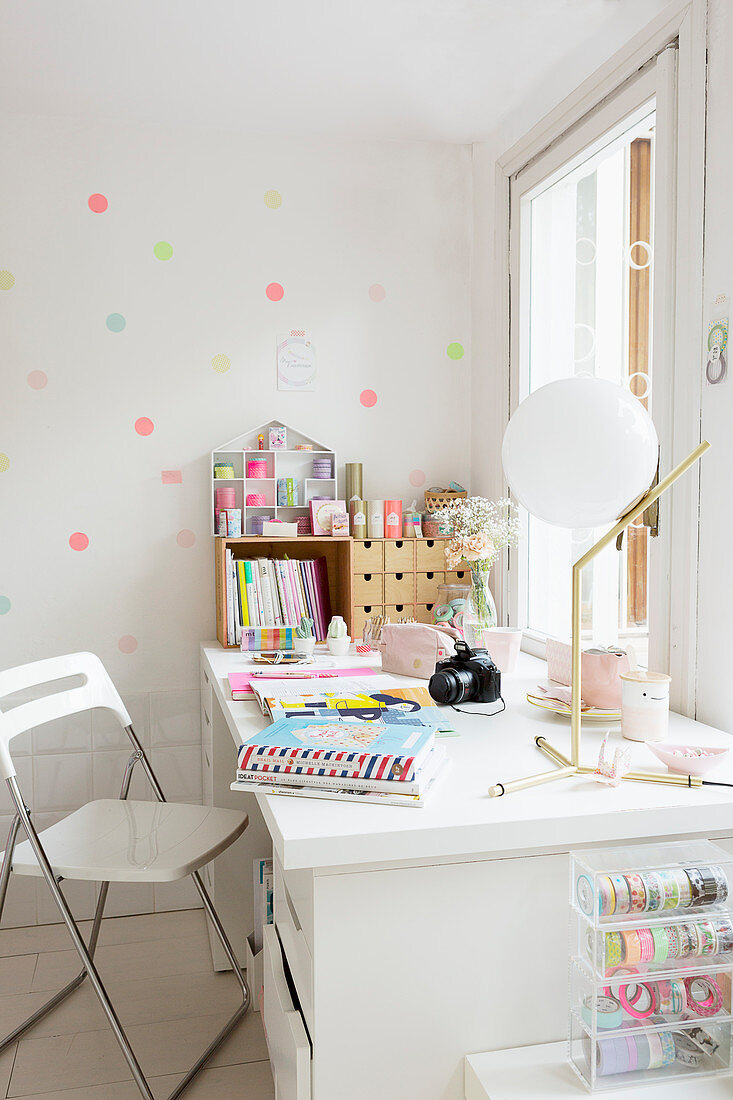 Polka-dots on wall behind desk below window