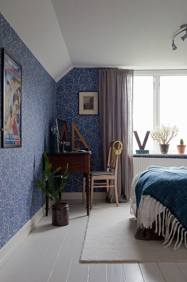 Blue and white bedroom with floral wallpaper