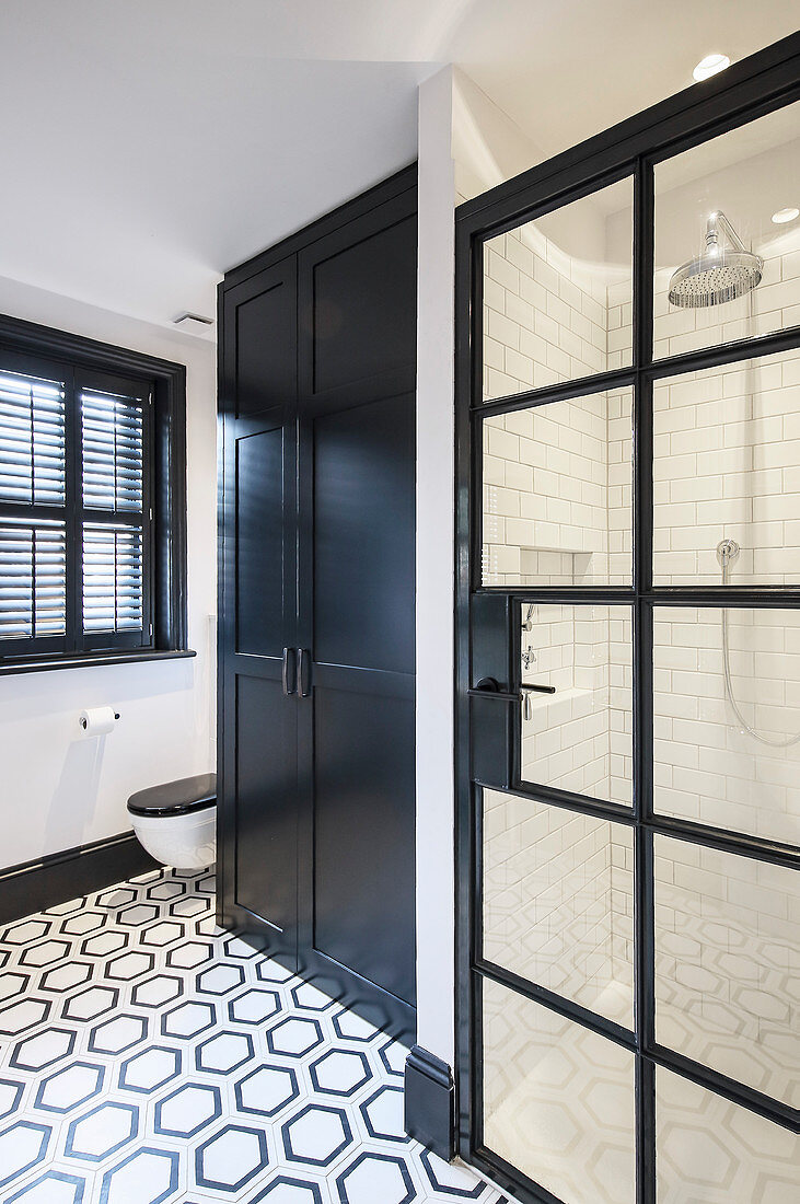 Patterned tiled floor in classic black-and-white bathroom