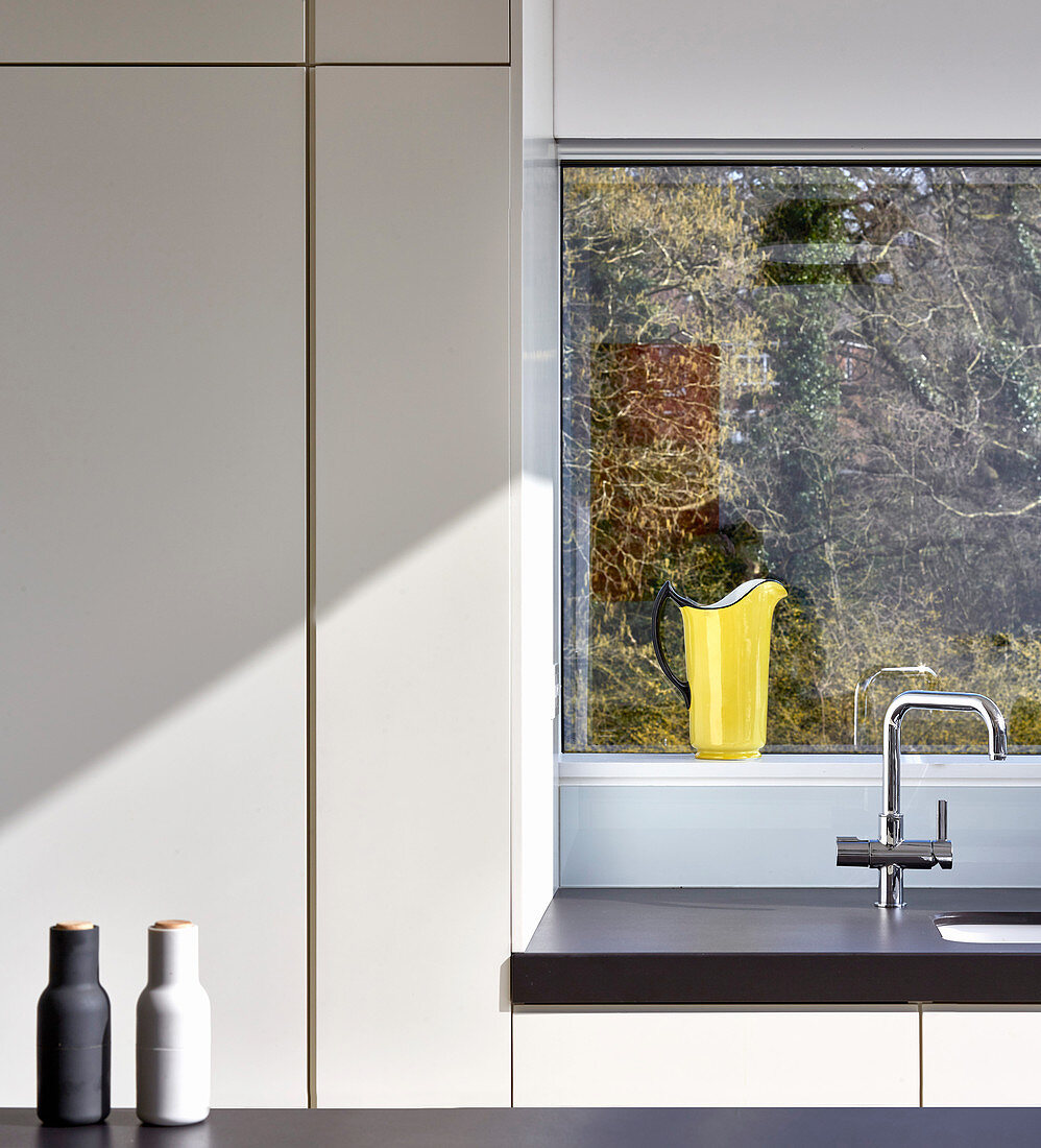 Patterns of straight lines and sunshine in minimalist modern kitchen