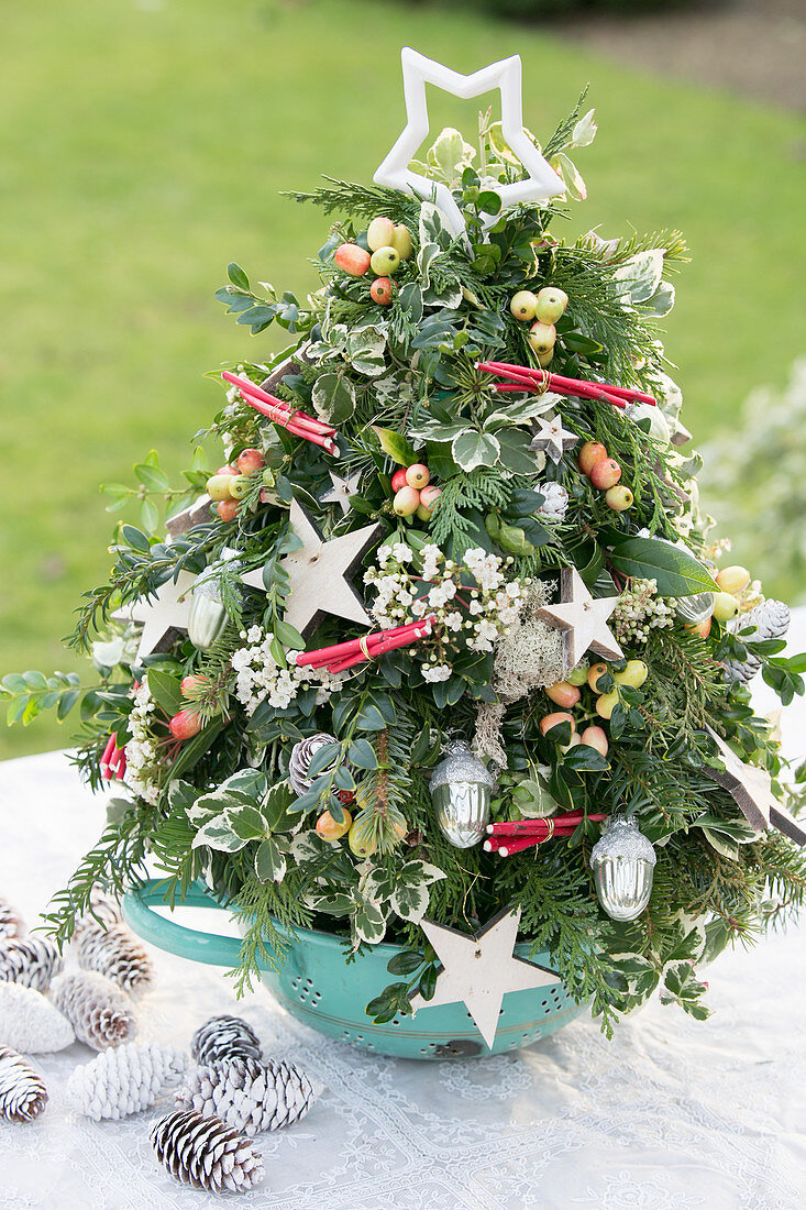 Festive arrangement in shape of Christmas tree in colander