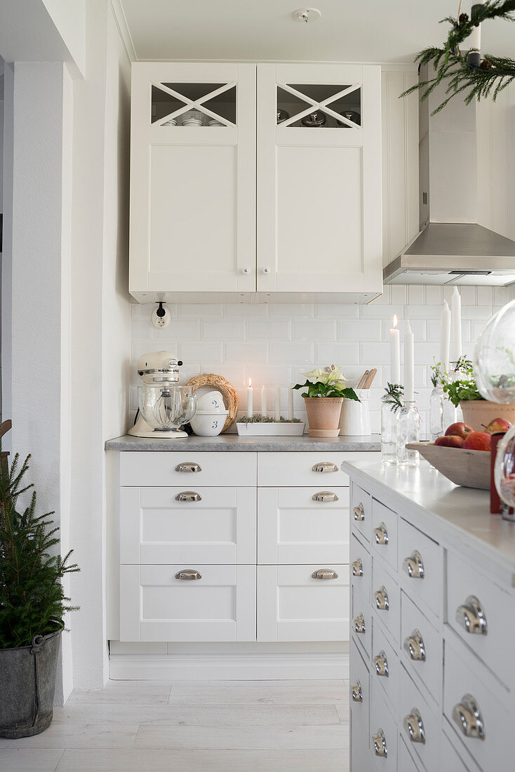 Island counter and Christmas decorations in bright fitted kitchen