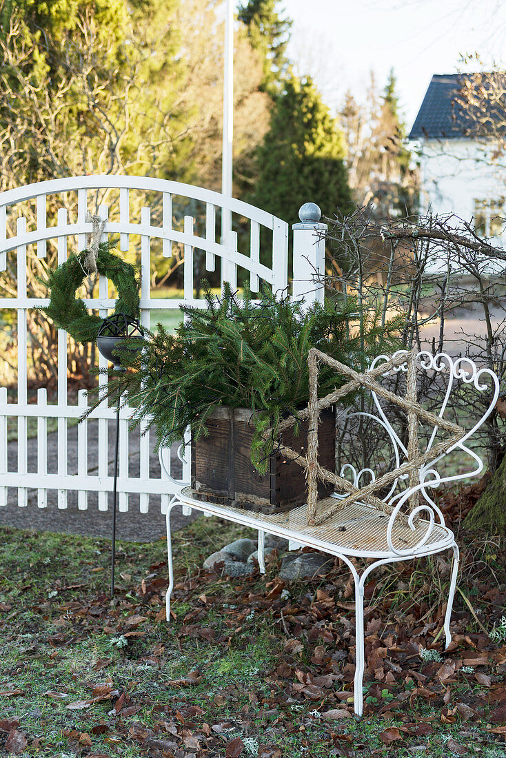 Festively decorated bench next to front gate