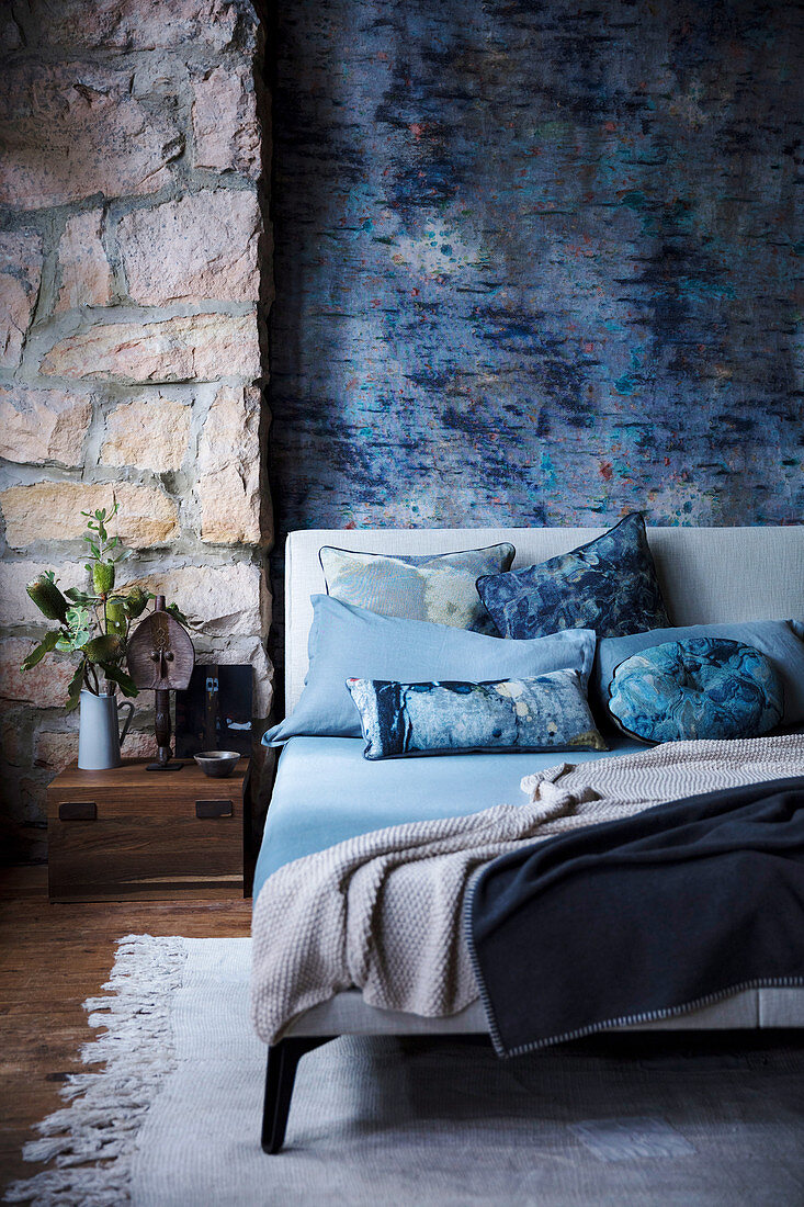 Mottled blue wall and natural stone wall in the bedroom