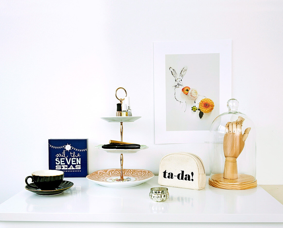 A cake stand as a shelf and various decorative items