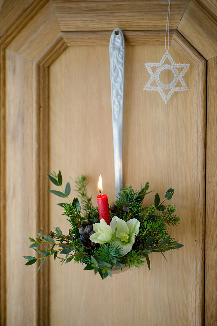 Festive arrangement with candle in ladle