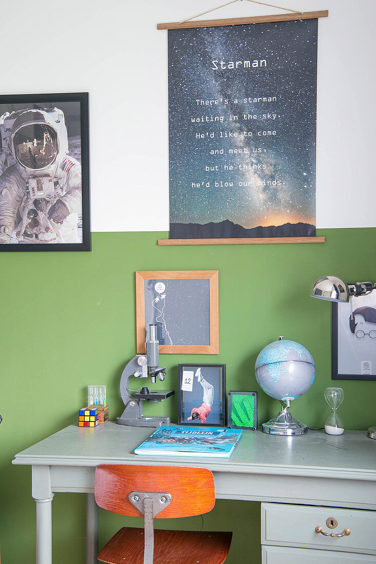 Two-tone wall and space-themed accessories in boy's bedroom