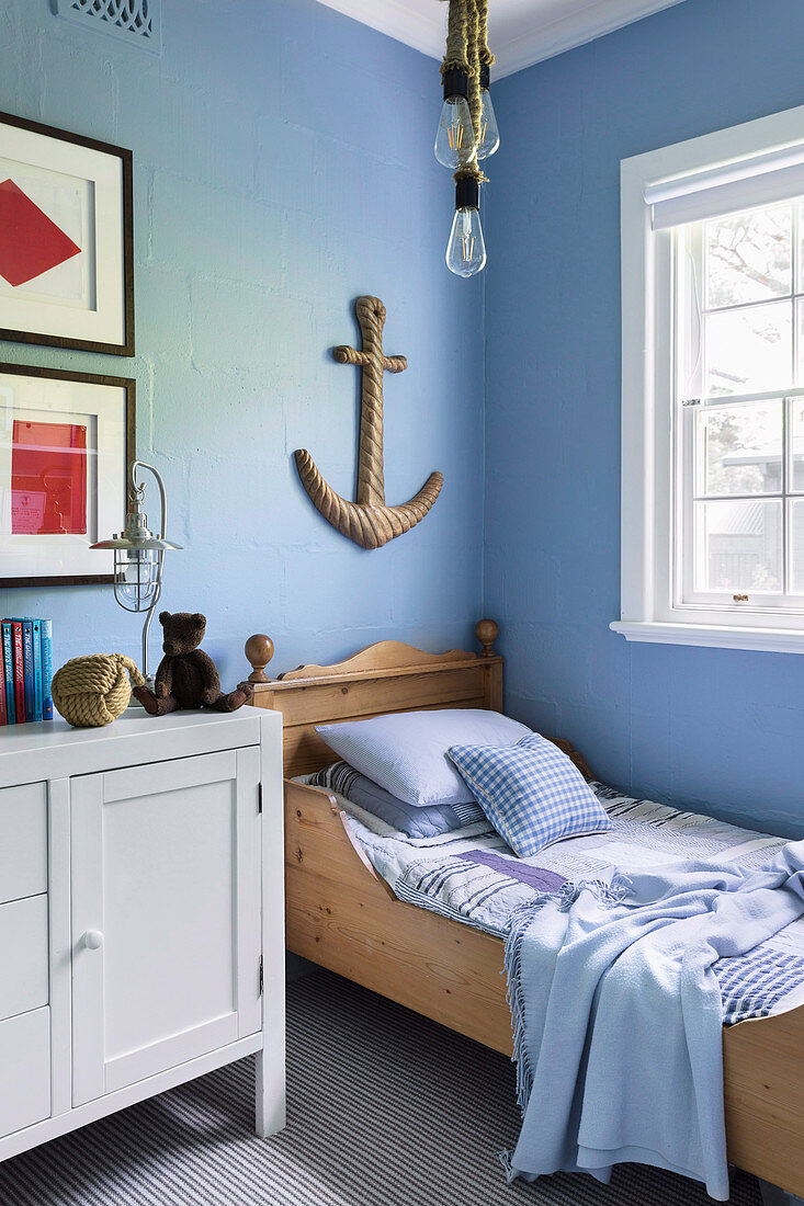 Maritime children's room with light blue wall and anchor