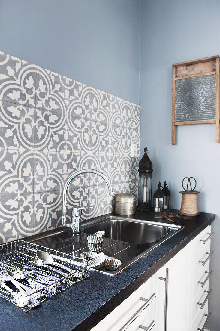 Splashback of classic patterned tiles above sink