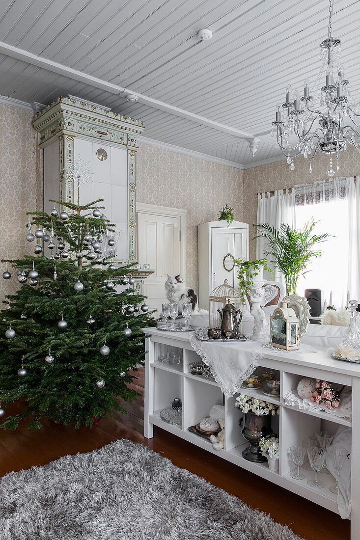 Christmas tree and white shelves in living room