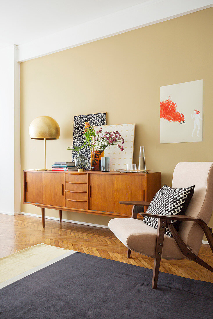 Armchair and retro sideboard in living room