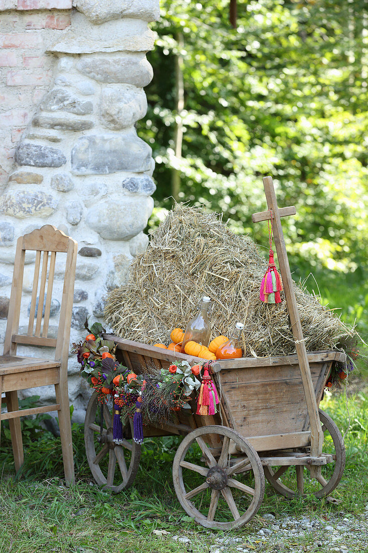 Handcart filled with straw and decorated for autumn