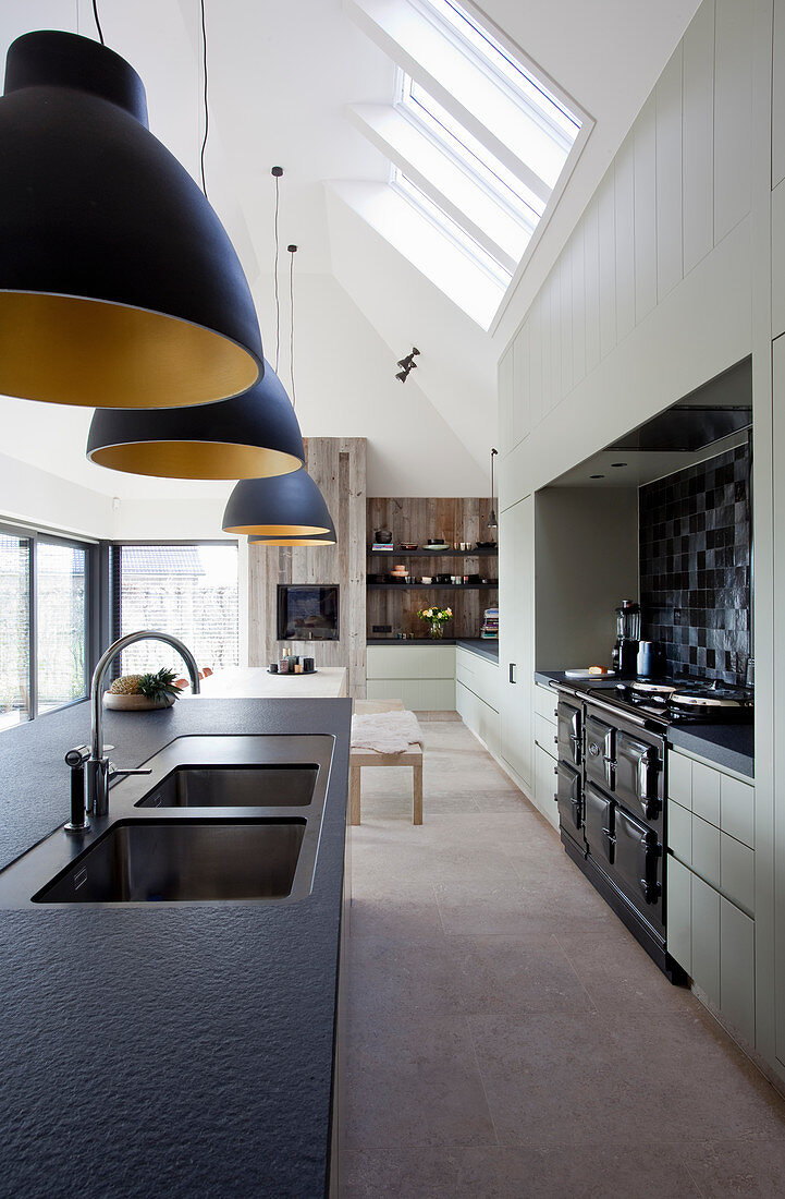 Luxurious, industrial-style kitchen-dining room with gable roof
