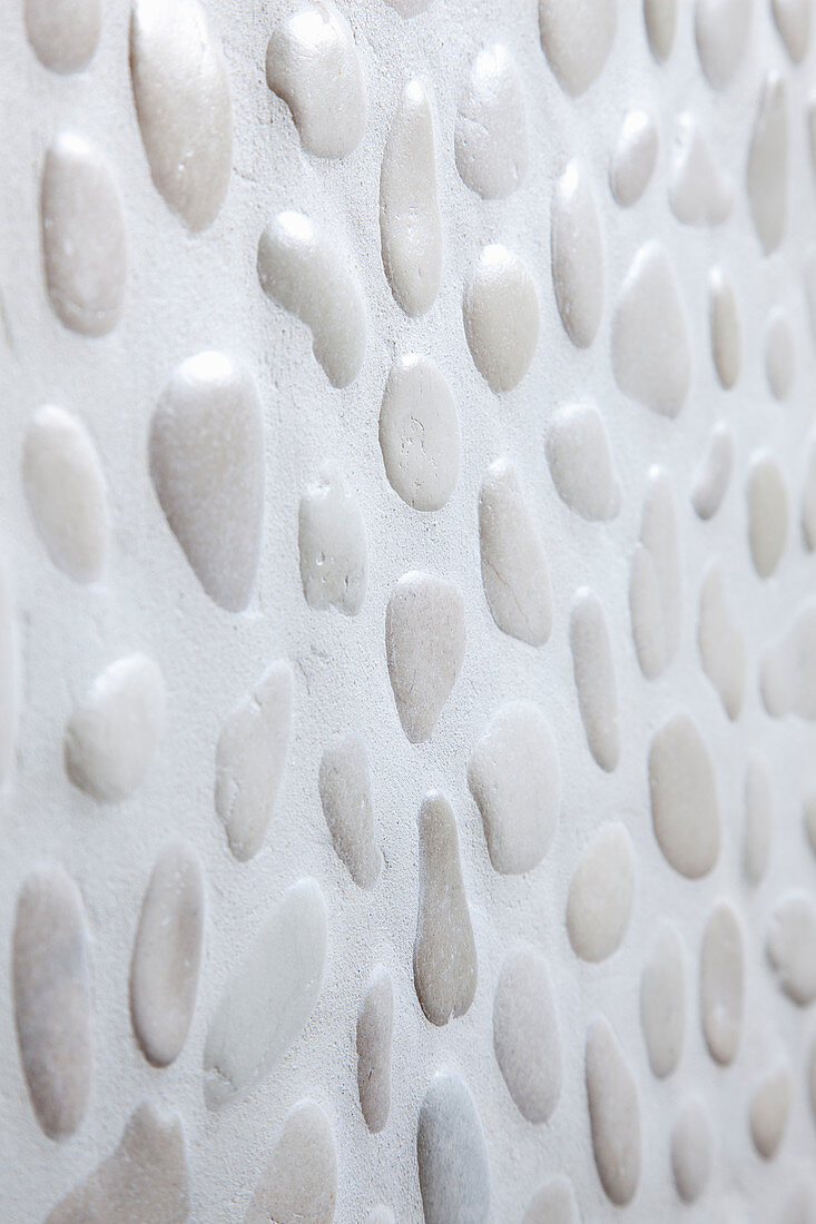 Wall clad with pebbles