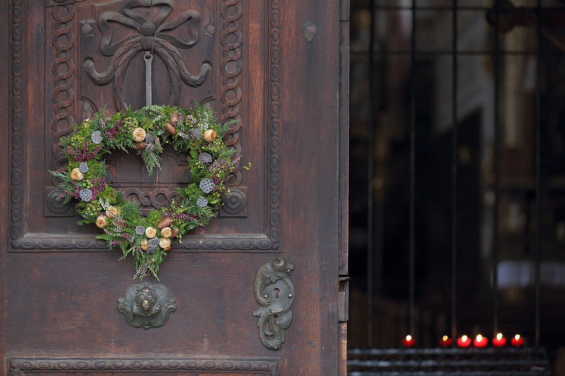 Heart-shaped wreath of heather and conifer twigs on church door