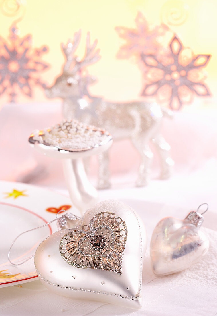 Snowflakes, silver hearts, mushroom and stag as Christmas decorations