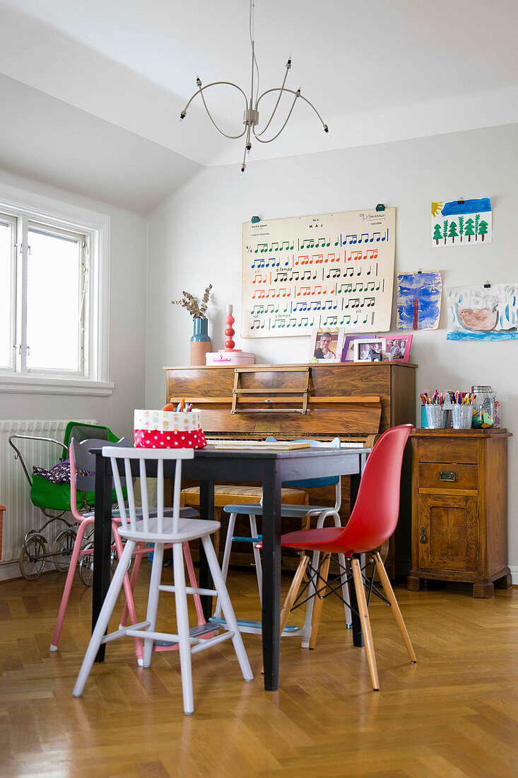 Various children's chair around table in front of piano