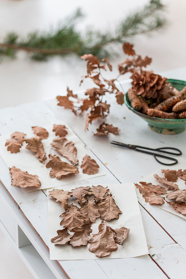 Dried oak leaves on white table made from pallet