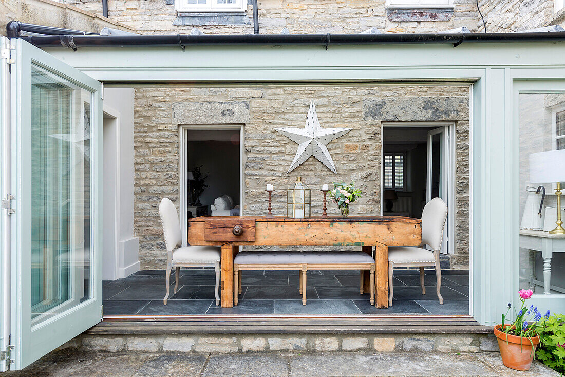 View through folding doors into dining room with workbench table