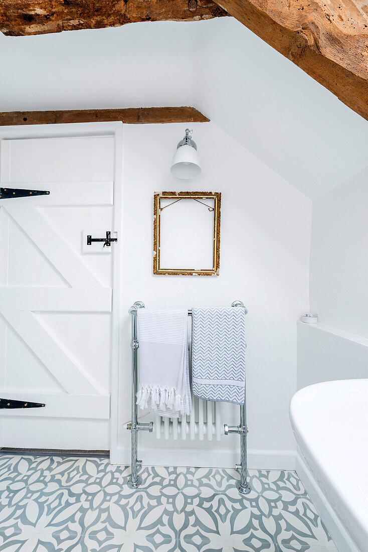 Vintage heated towel rail in rustic bathroom