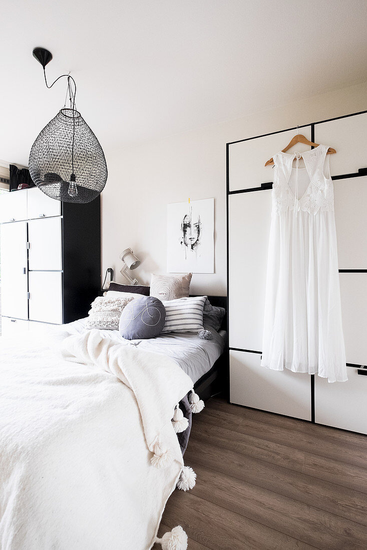 Bed between two wardrobes in bedroom