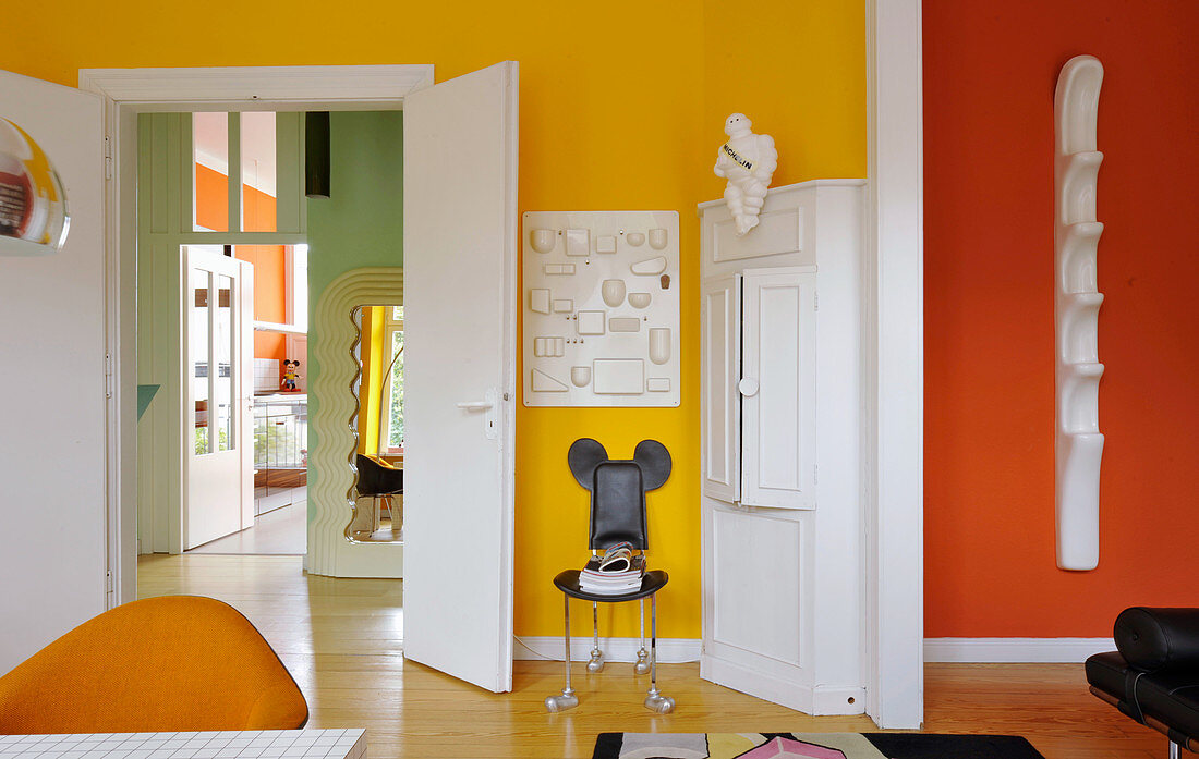 Brightly coloured walls and retro furnishings in living room