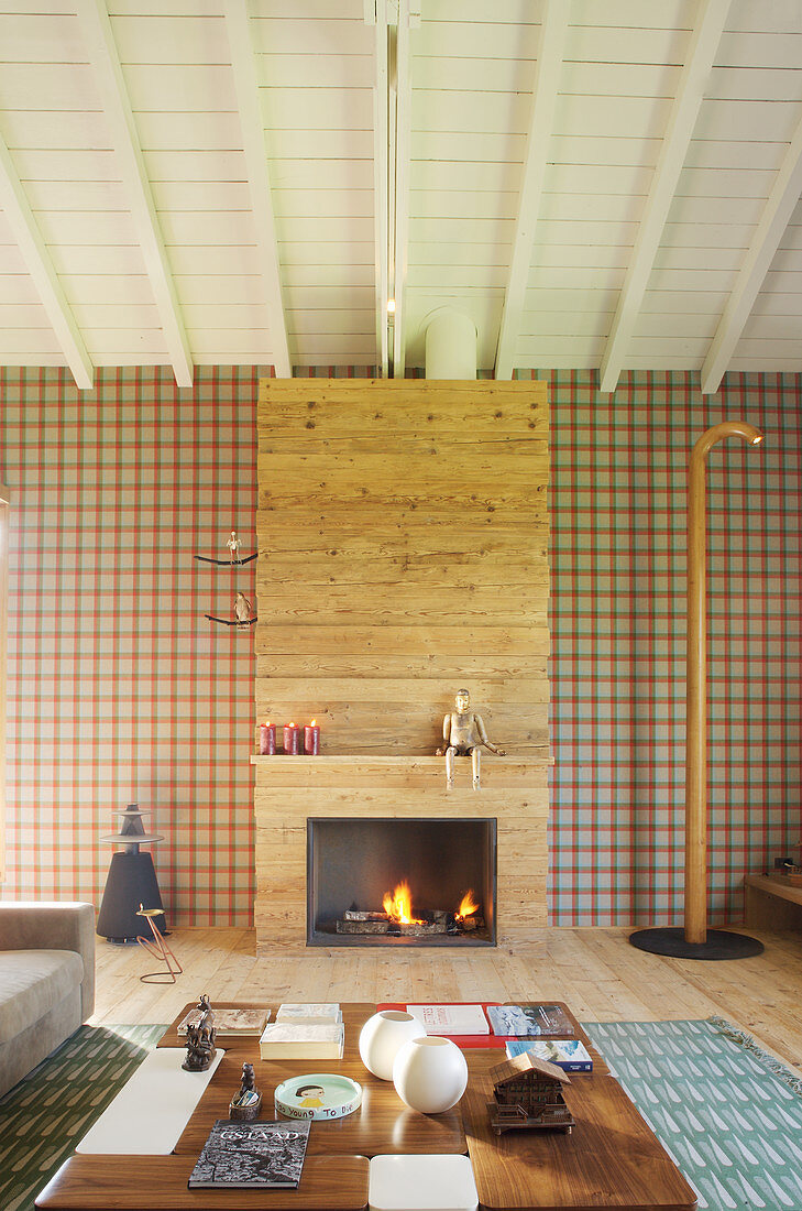Fireplace and tartan wallpaper in elegant living room
