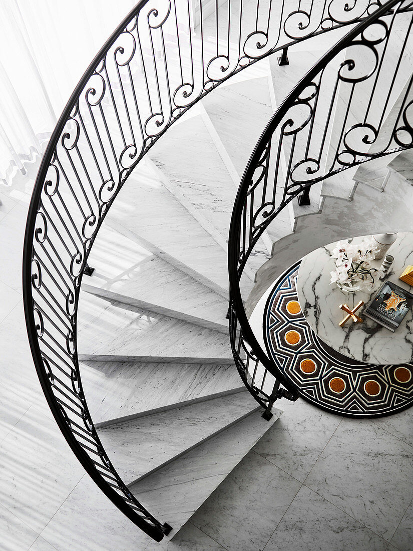 Elegant spiral marble staircase, view of marble table