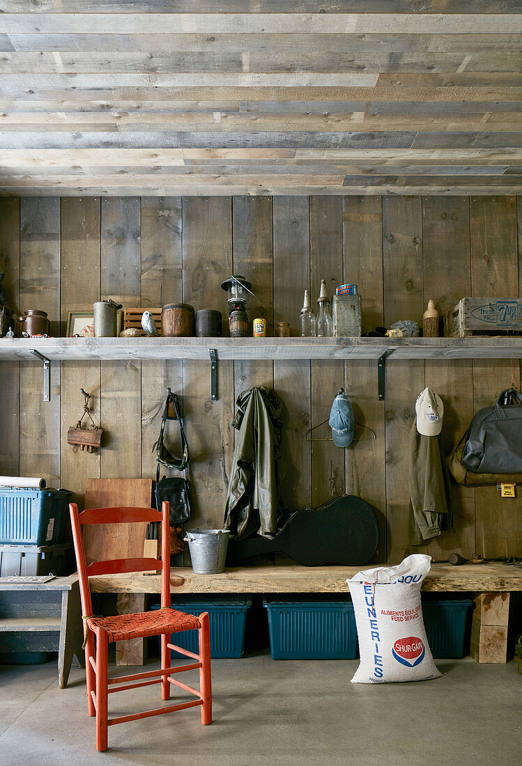 Rustic cloakroom with wood-clad wall and ceiling
