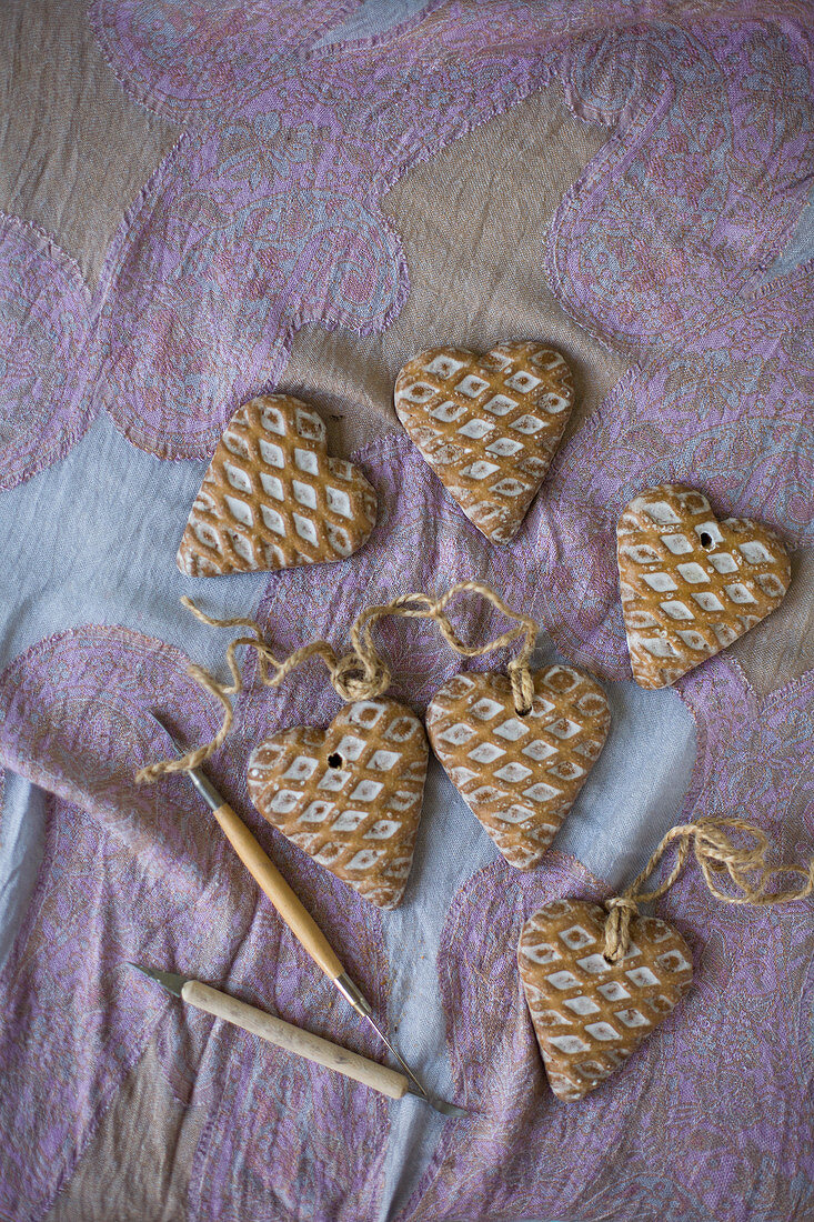 Heart-shaped pendants with waffle structure on pink patterned cloth